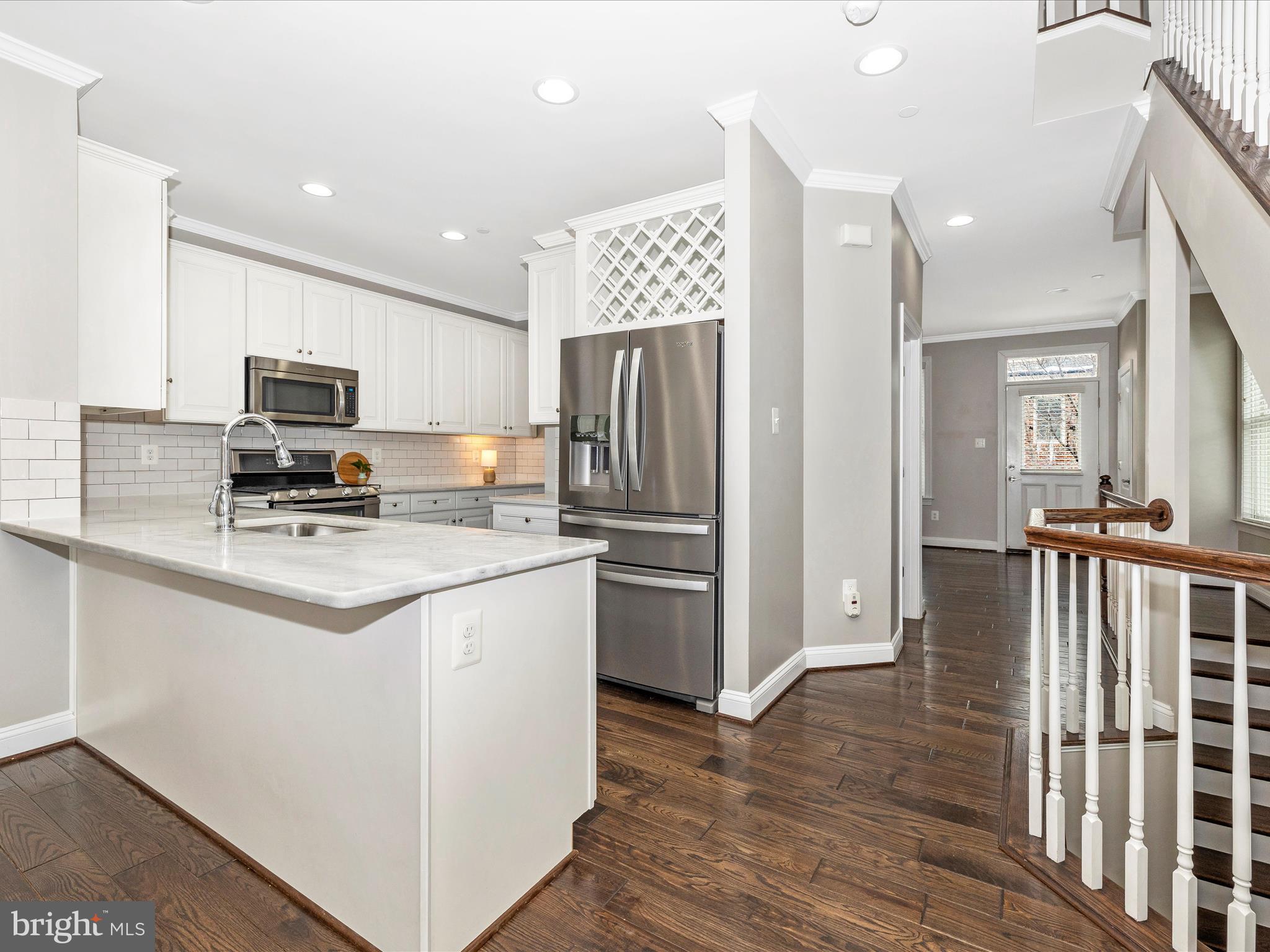2 Maxwell Square Frederick, MD 21701 - Photo 12 of 59 a kitchen with stainless steel appliances a refrigerator stove microwave and cabinets
