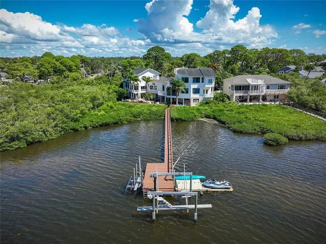 an aerial view of a house with outdoor space and lake view