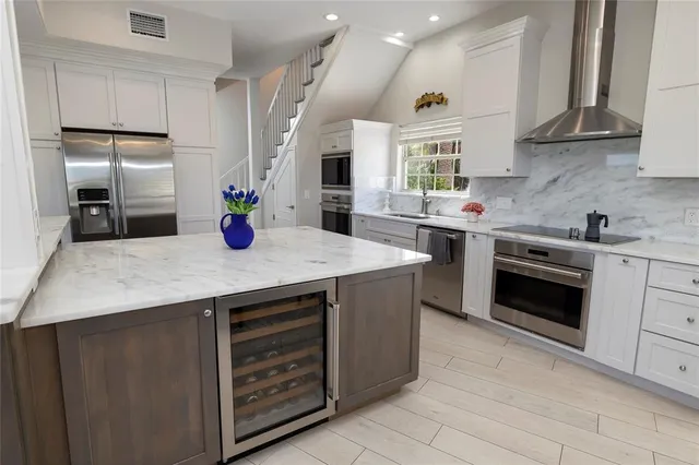a bedroom with two beds and a chandelier