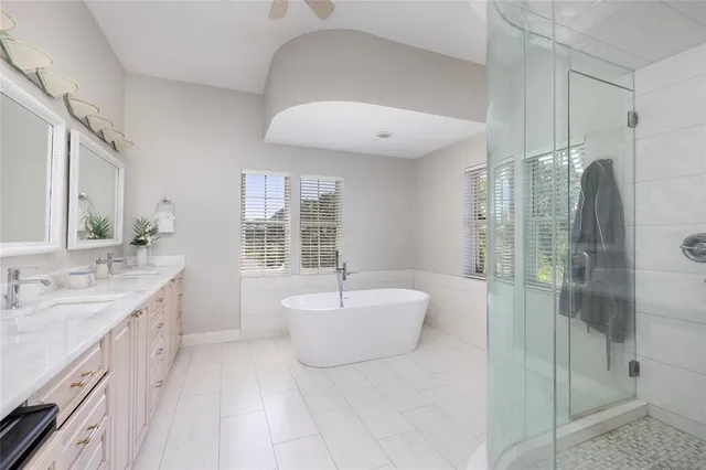 a living room with hardwood floor and large windows