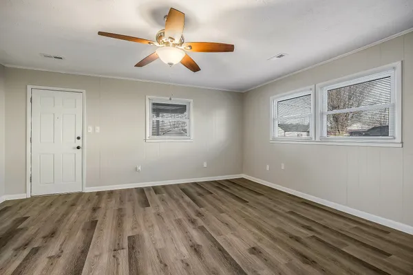 a view of empty room with wooden floor