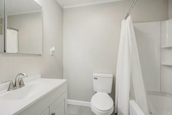 a white toilet sitting next to a bathroom sink