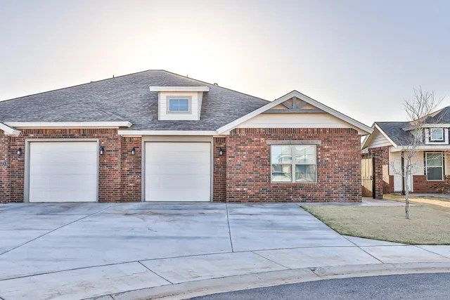a front view of a house with yard and garage