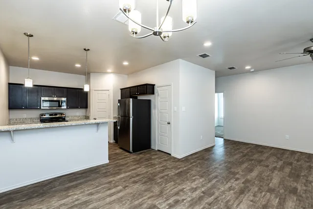 a view of kitchen with stainless steel appliances a refrigerator and a microwave