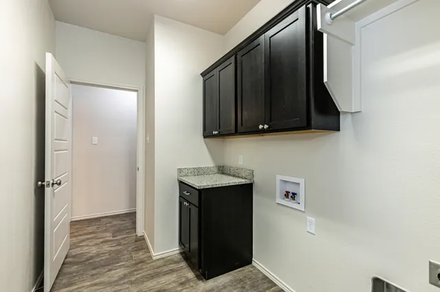 a kitchen with a refrigerator and a stove top oven