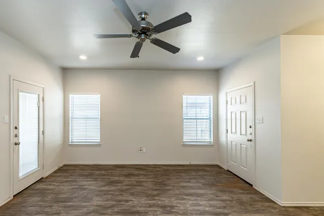 an empty room with windows and closet
