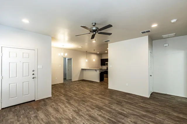 a view of a kitchen with a sink and a refrigerator