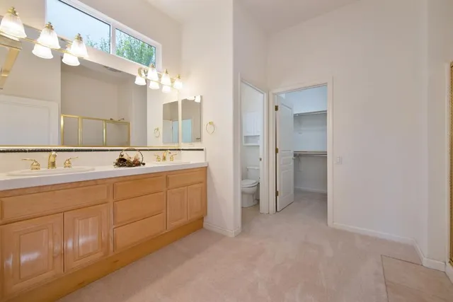 a spacious bathroom with a double vanity sink mirror and double