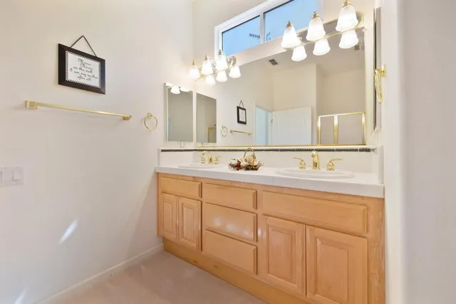 a bathroom with a sink vanity and a mirror