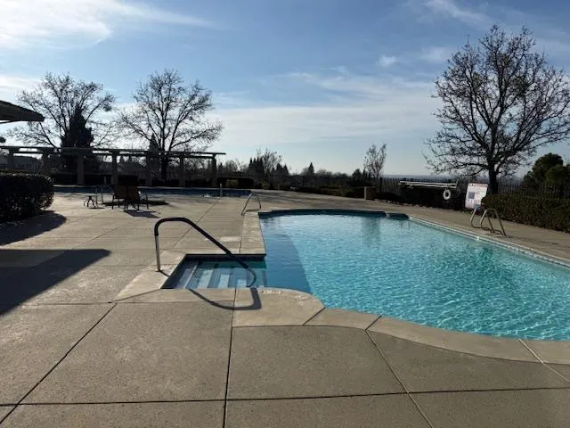 a view of a swimming pool with an outdoor seating