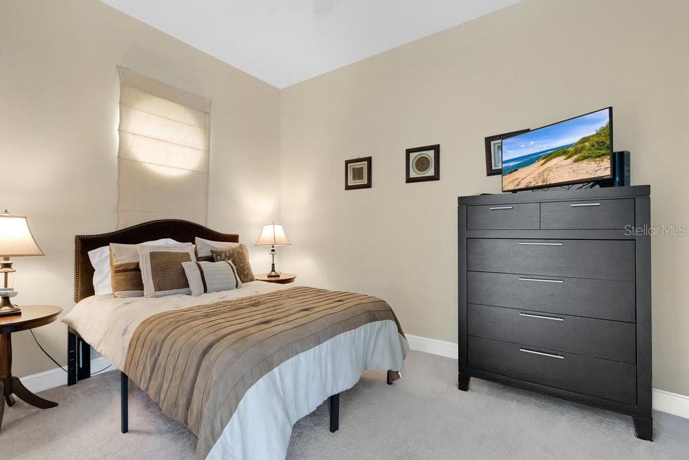 7404 Oconee Street Reunion, FL 34747 - Photo 16 of 87 a bedroom with a bed and a night stand