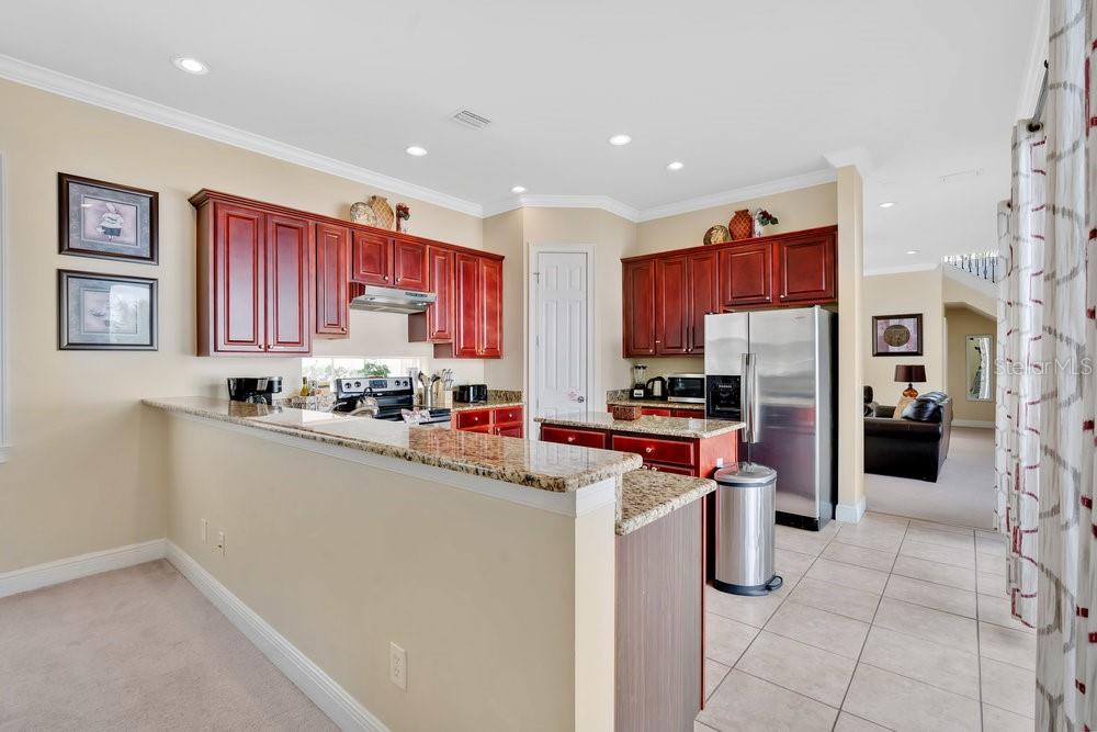 7404 Oconee Street Reunion, FL 34747 - Photo 4 of 87 a kitchen with stainless steel appliances a refrigerator and a stove