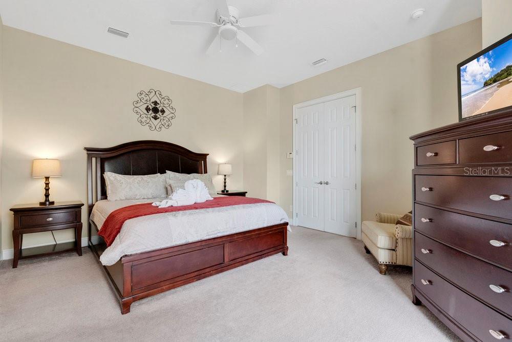 7404 Oconee Street Reunion, FL 34747 - Photo 10 of 87 a bedroom with a bed and lamp on dresser