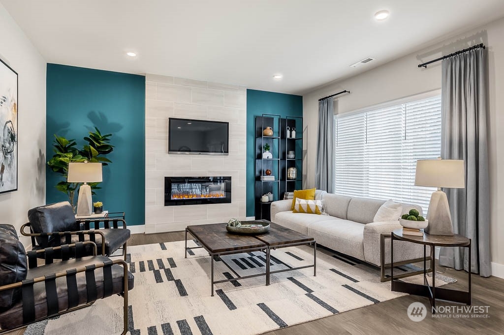 22905 20th Place West Bothell, WA 98021 - Photo 2 of 26 a living room with furniture a flat screen tv and a fireplace