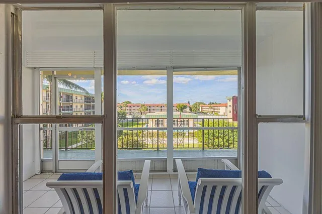 a view of a room with wooden floor and windows