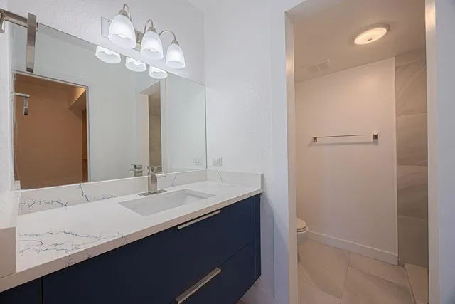 a bathroom with a sink a light fixture and a mirror