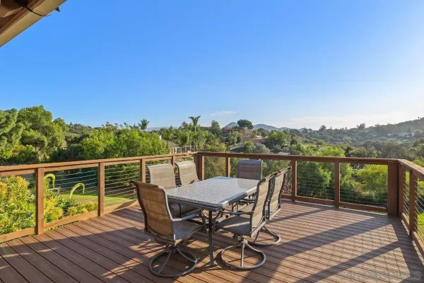 a view of a chair and table on the deck