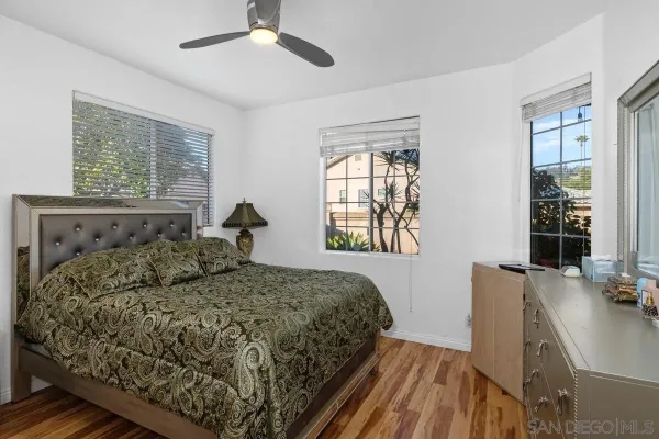 a bed sitting in a bedroom next to a window