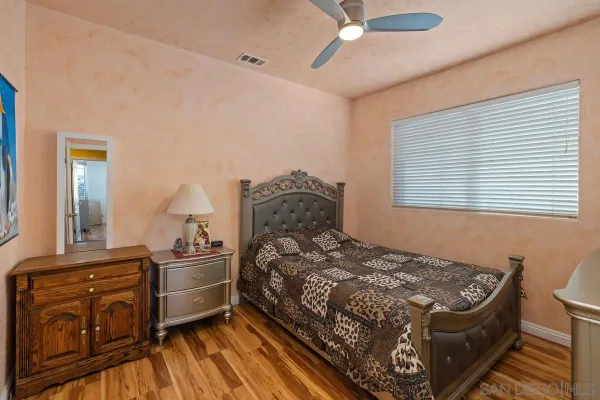 a bed sitting in a bedroom next to a window