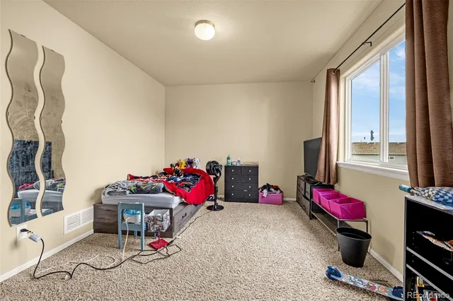 a bedroom with furniture and a potted plant