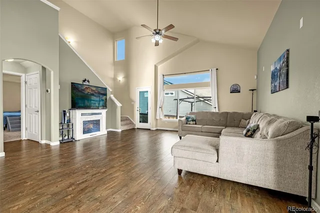 a living room with furniture and a wooden floor
