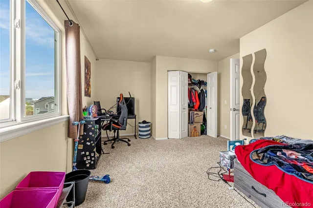 a living room with furniture gym equipment and a window