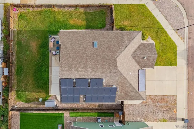 an aerial view of a house with a yard