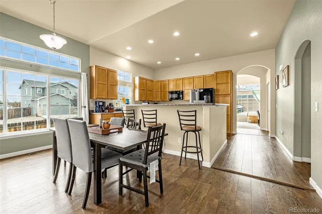 a view of a dining room with furniture window and wooden floor