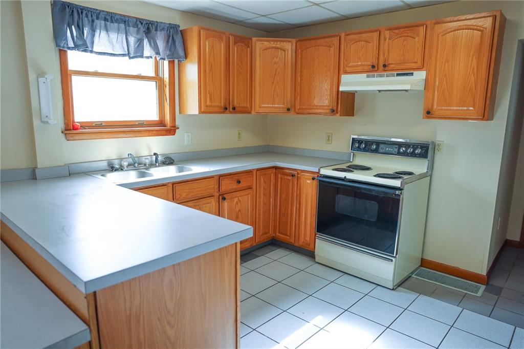 221 2nd Street, Unit 5 Smithton, PA 15479 - Photo 3 of 13 a kitchen with a sink stove and cabinets
