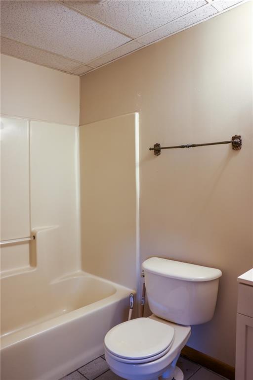 221 2nd Street, Unit 5 Smithton, PA 15479 - Photo 9 of 13 a white toilet sitting next to a bath tub and a shower