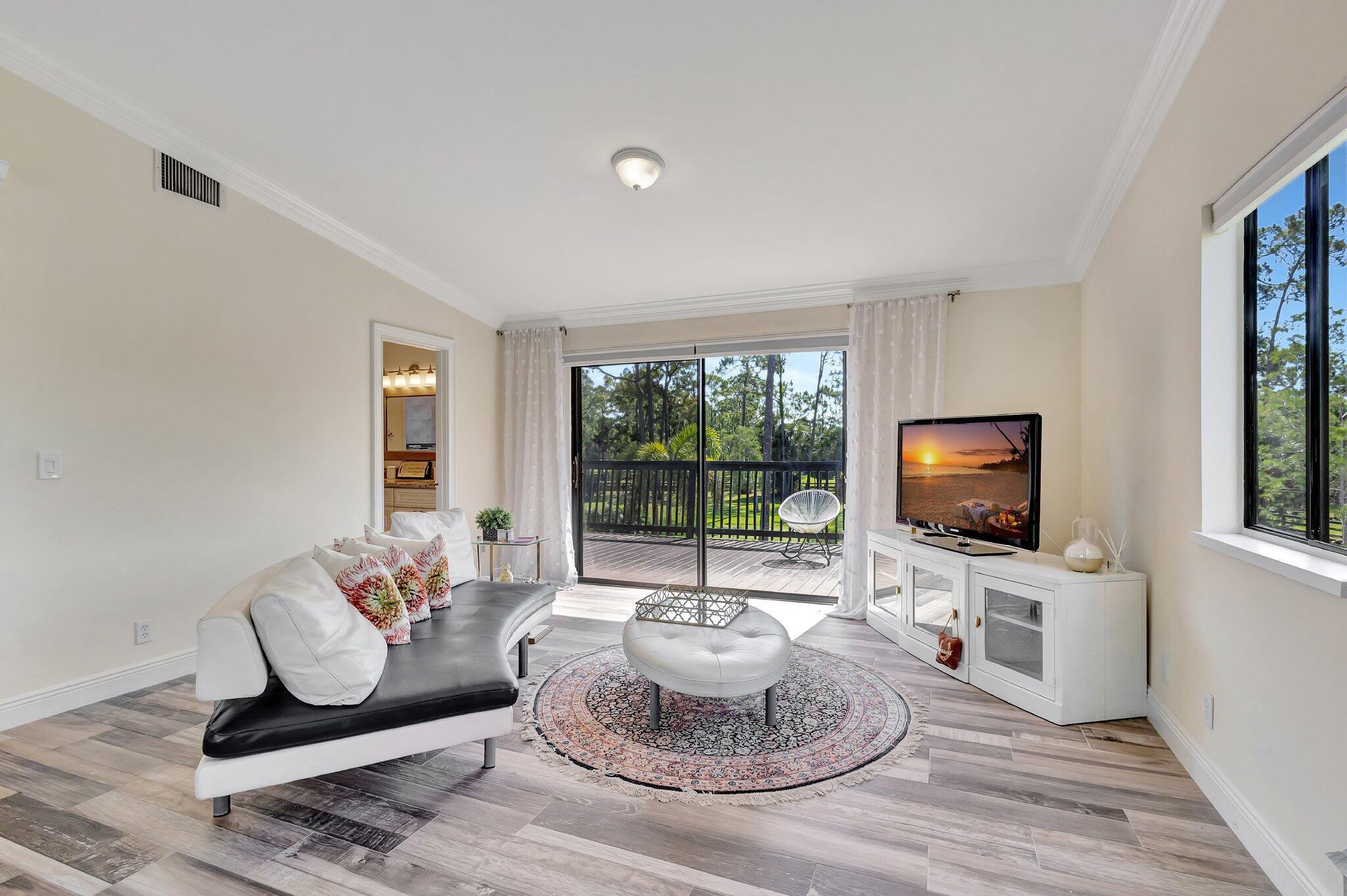 5446 Reynolds Road Lake Worth, FL 33449 - Photo 22 of 57 a living room with furniture and a flat screen tv