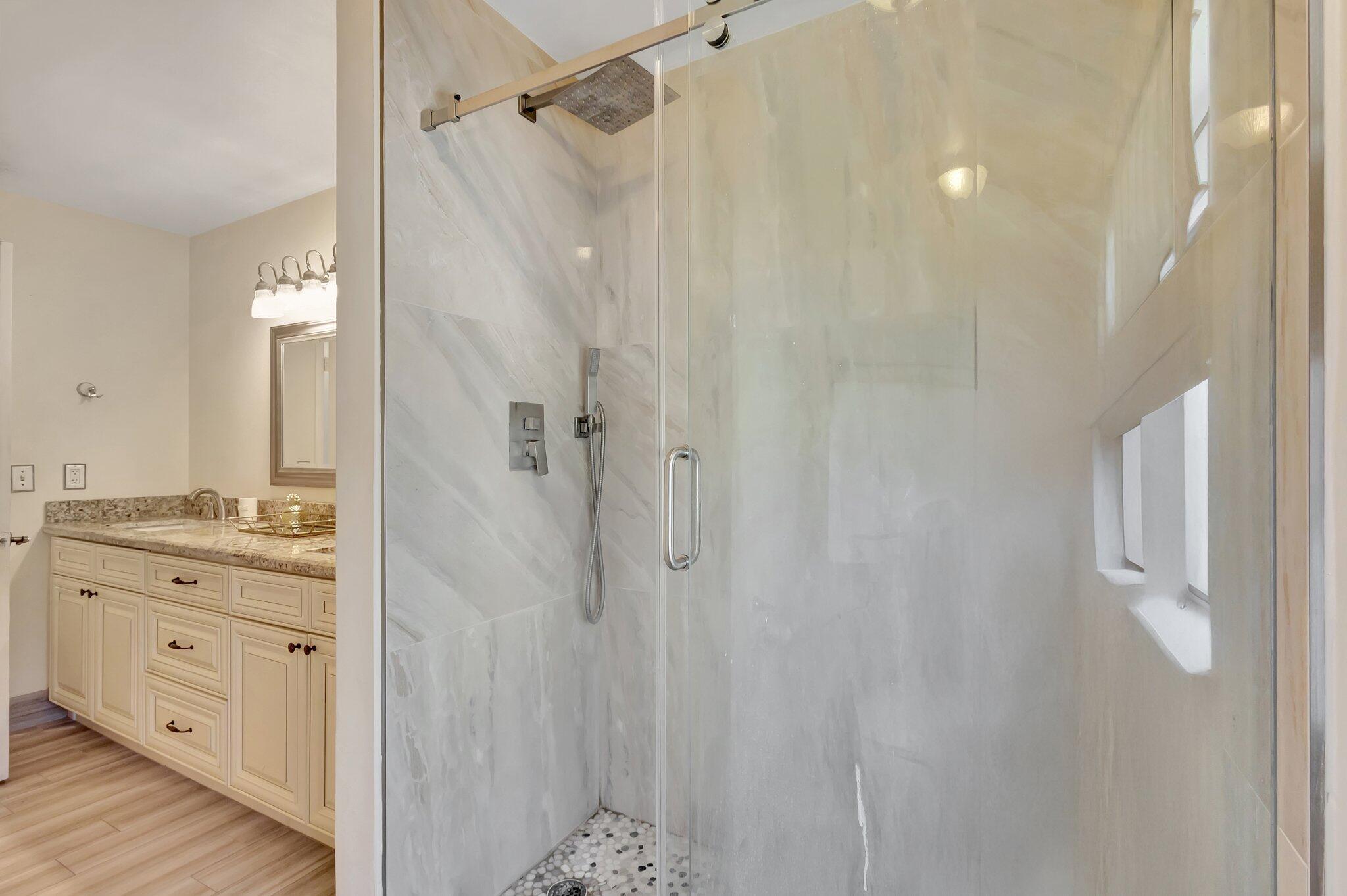 5446 Reynolds Road Lake Worth, FL 33449 - Photo 29 of 57 a bathroom with a granite countertop shower sink vanity and mirror