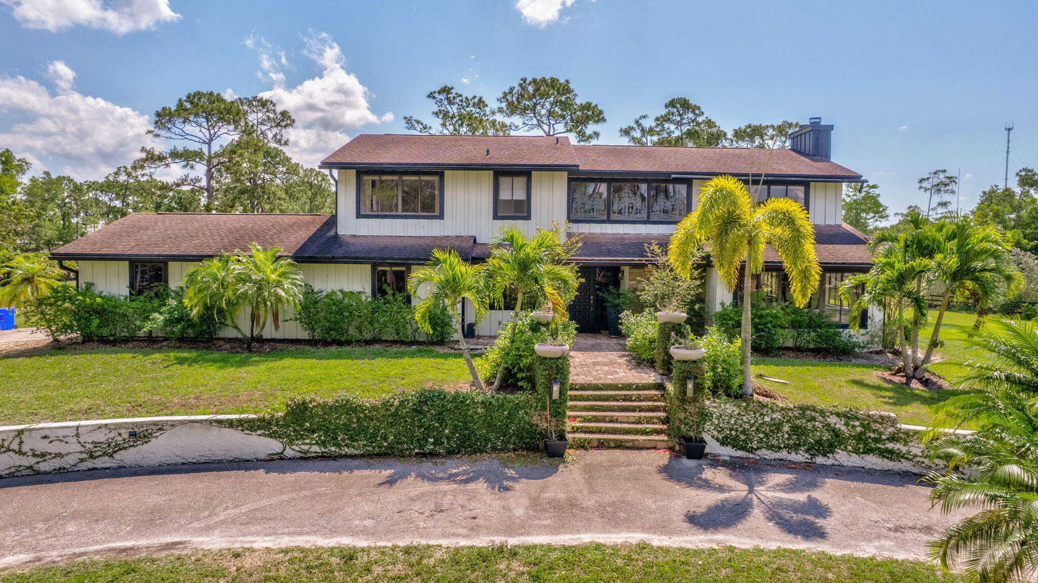 5446 Reynolds Road Lake Worth, FL 33449 - Photo 3 of 57 a front view of a house with garden