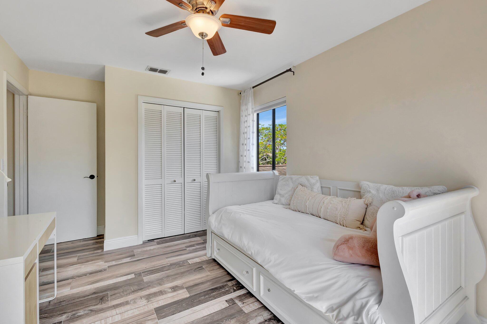 5446 Reynolds Road Lake Worth, FL 33449 - Photo 31 of 57 a spacious bedroom with a bed and a chandelier