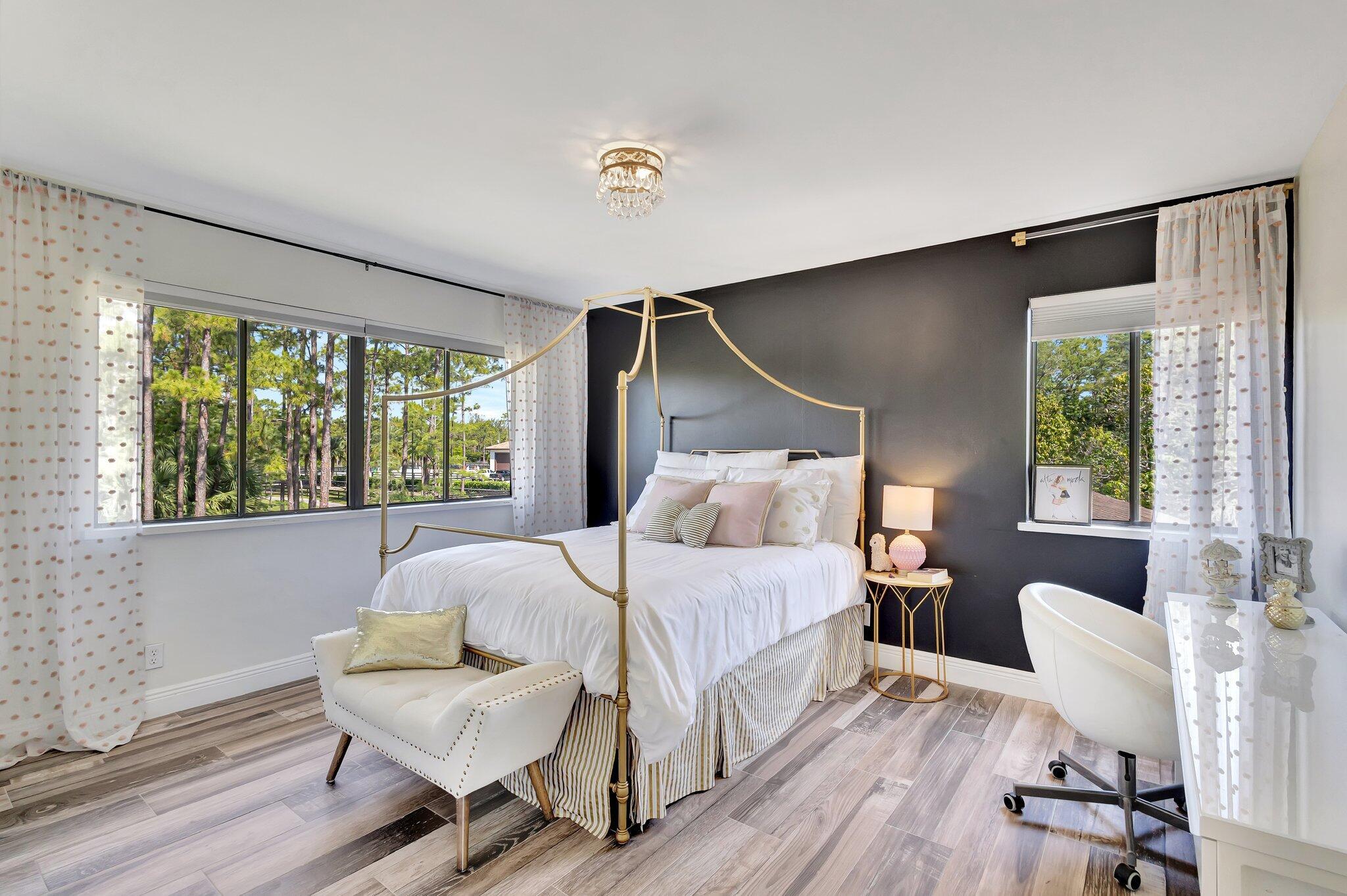 5446 Reynolds Road Lake Worth, FL 33449 - Photo 34 of 57 a bedroom with a bed and wooden floor