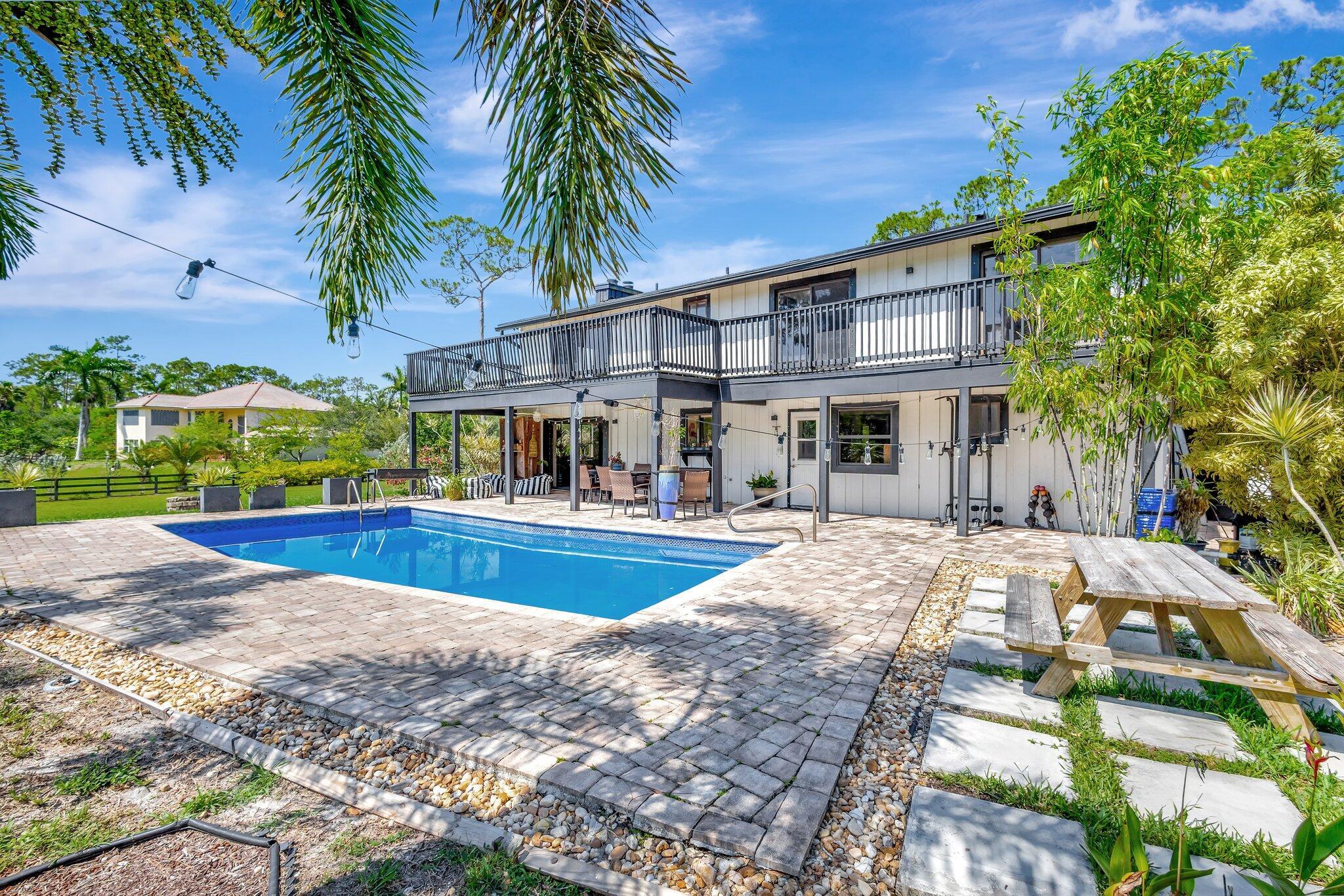 5446 Reynolds Road Lake Worth, FL 33449 - Photo 45 of 57 a view of a house with a swimming pool