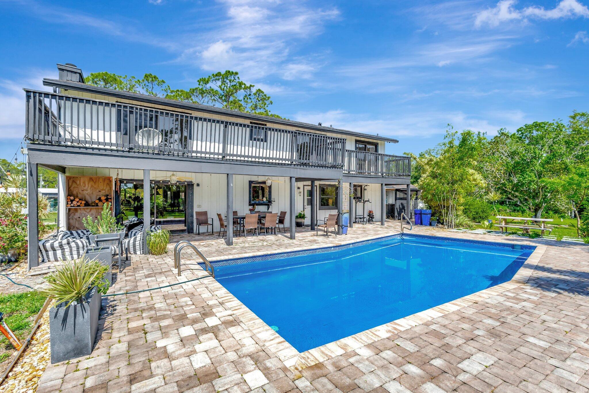 5446 Reynolds Road Lake Worth, FL 33449 - Photo 47 of 57 a view of a house with swimming pool and sitting area
