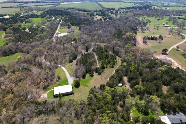 an aerial view of a house with outdoor space
