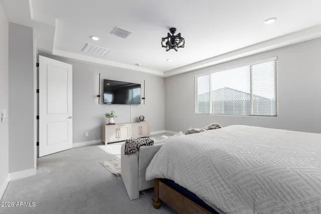 a spacious bathroom with a tub sink and mirror