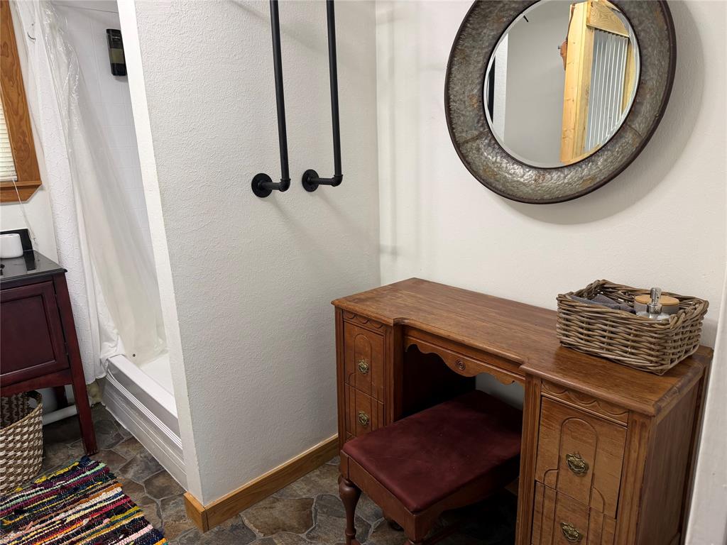 111 Apache Trail Whitney, TX 76692 - Photo 25 of 40 a bathroom with a sink a mirror and a toilet
