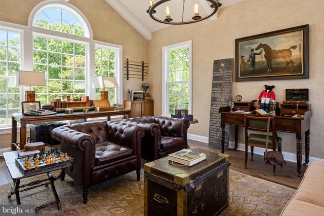 a living room with furniture a window and a flat screen tv