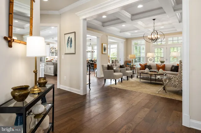 a living room with furniture dining table and a chandelier