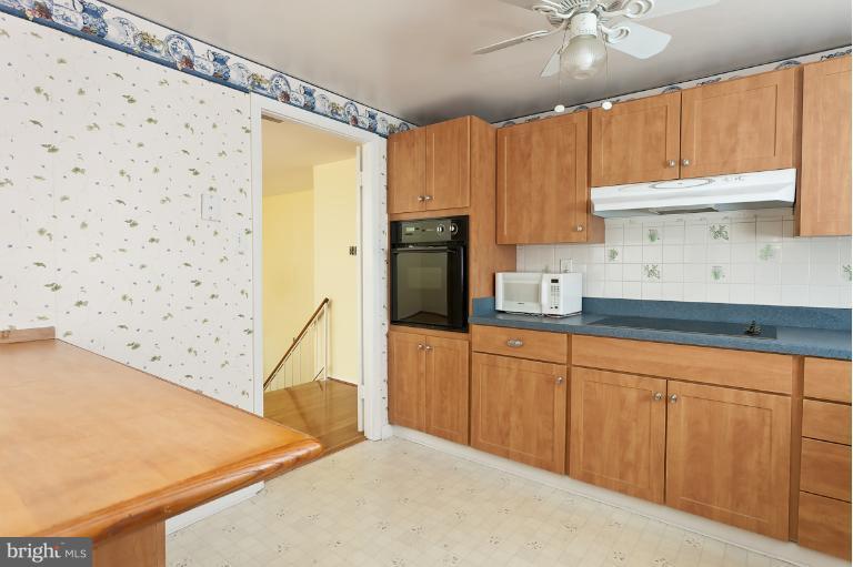 412 Haverhill Road Joppa, MD 21085 - Photo 2 of 20 a kitchen with granite countertop a refrigerator a sink and dishwasher