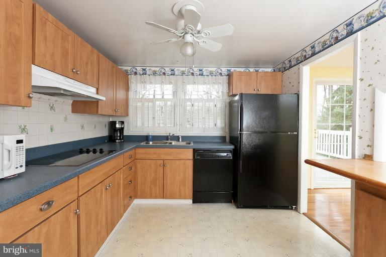 412 Haverhill Road Joppa, MD 21085 - Photo 3 of 20 a kitchen with granite countertop a refrigerator a sink a stove and cabinets