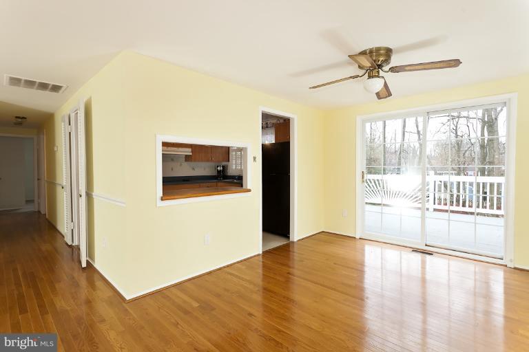 412 Haverhill Road Joppa, MD 21085 - Photo 6 of 20 a view of an empty room with wooden floor and a window