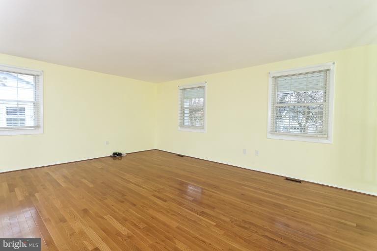 412 Haverhill Road Joppa, MD 21085 - Photo 10 of 20 a view of an empty room with wooden floor and a window