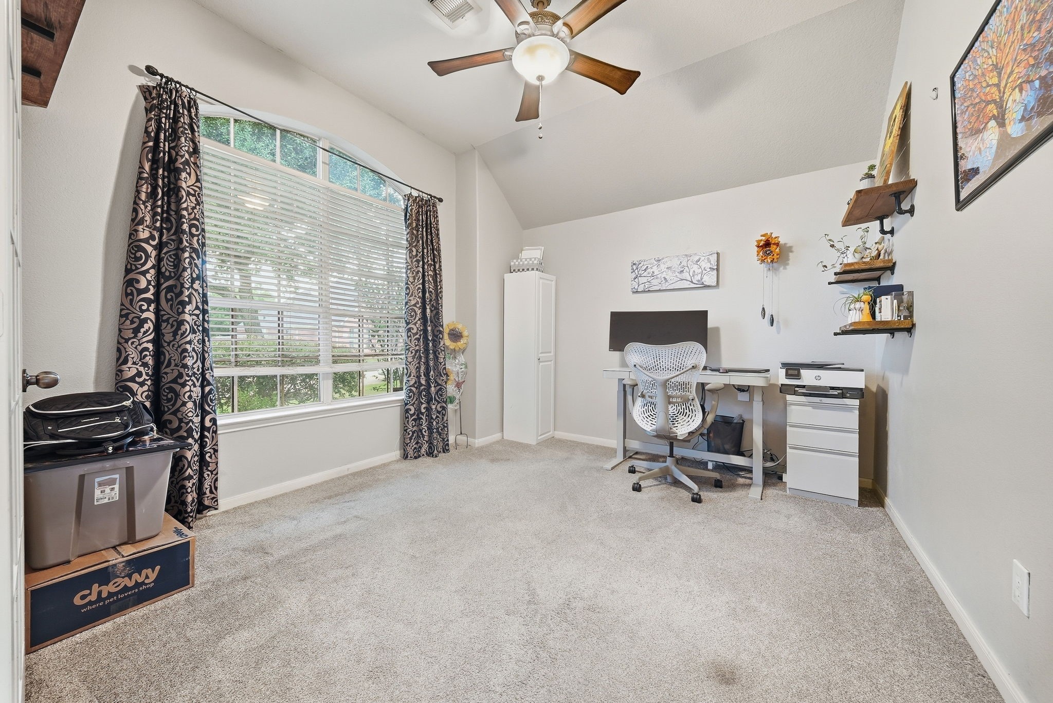 2223 Lazy Trail Path Court Spring, TX 77373 - Photo 4 of 23 Bright home office with a large arched window, modern furnishings, and ample space for productivity.