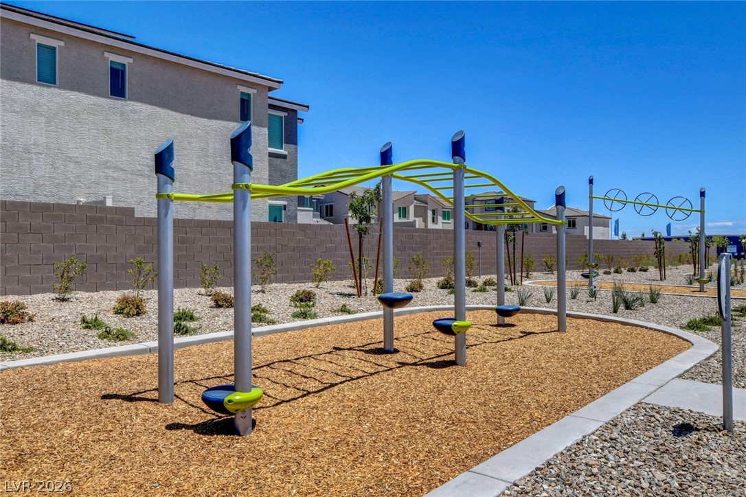 6924 Spicy Merlot Street North Las Vegas, NV 89086 - Photo 81 of 83 A vibrant playground structure invites activity in a sun-drenched outdoor setting.