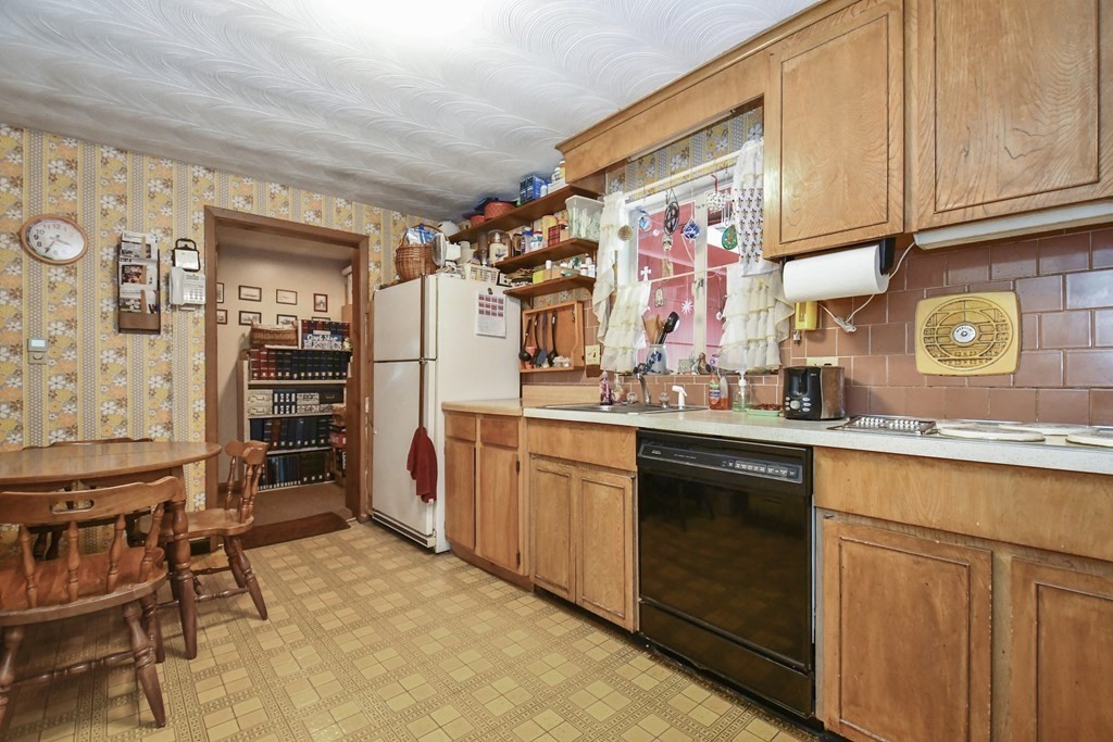 3 Clarissa Road Chelmsford, MA 01824 - Photo 9 of 15 a kitchen with stainless steel appliances granite countertop a sink and cabinets