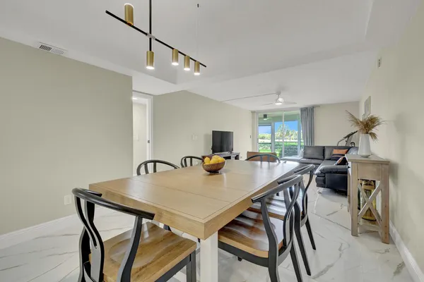 a view of a dining room with furniture and a chandelier
